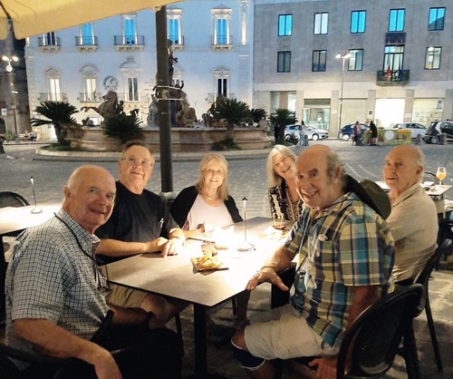 Dinner with friends on a square in Sirausa, Italy